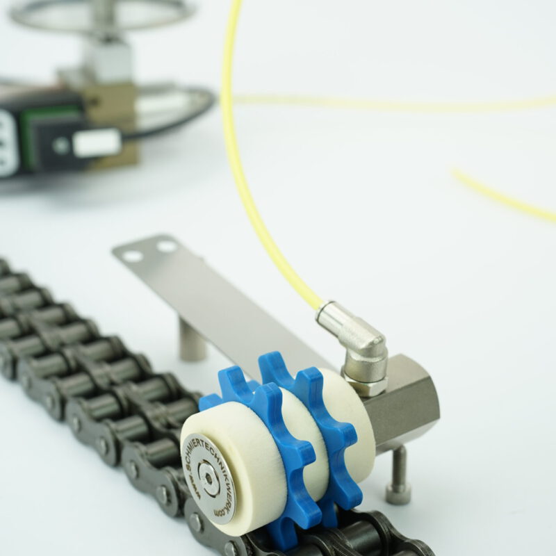 Kettenschmierritzel mit Federblech